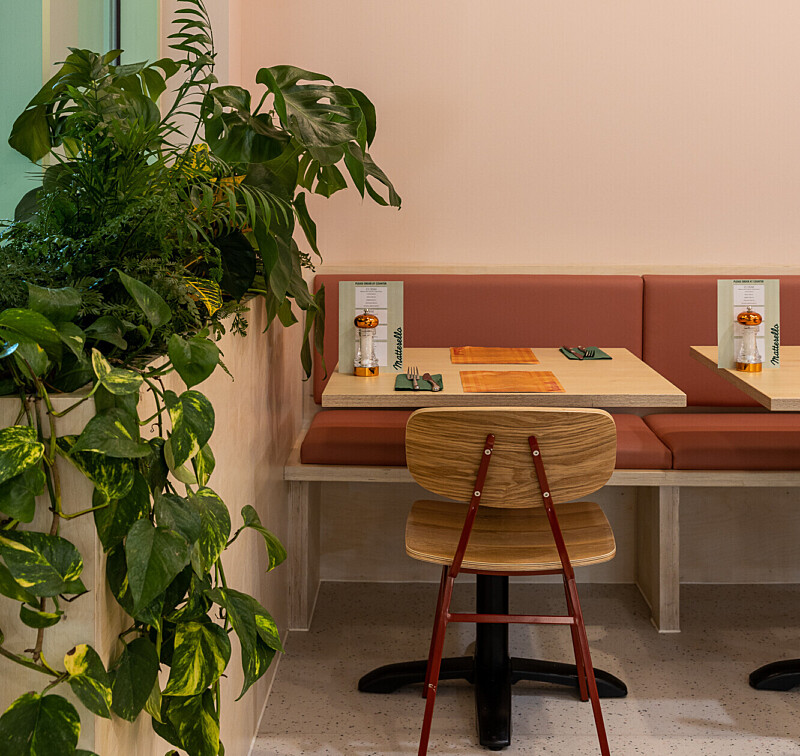 Seating with plants in Matterello interior, italian resaurant