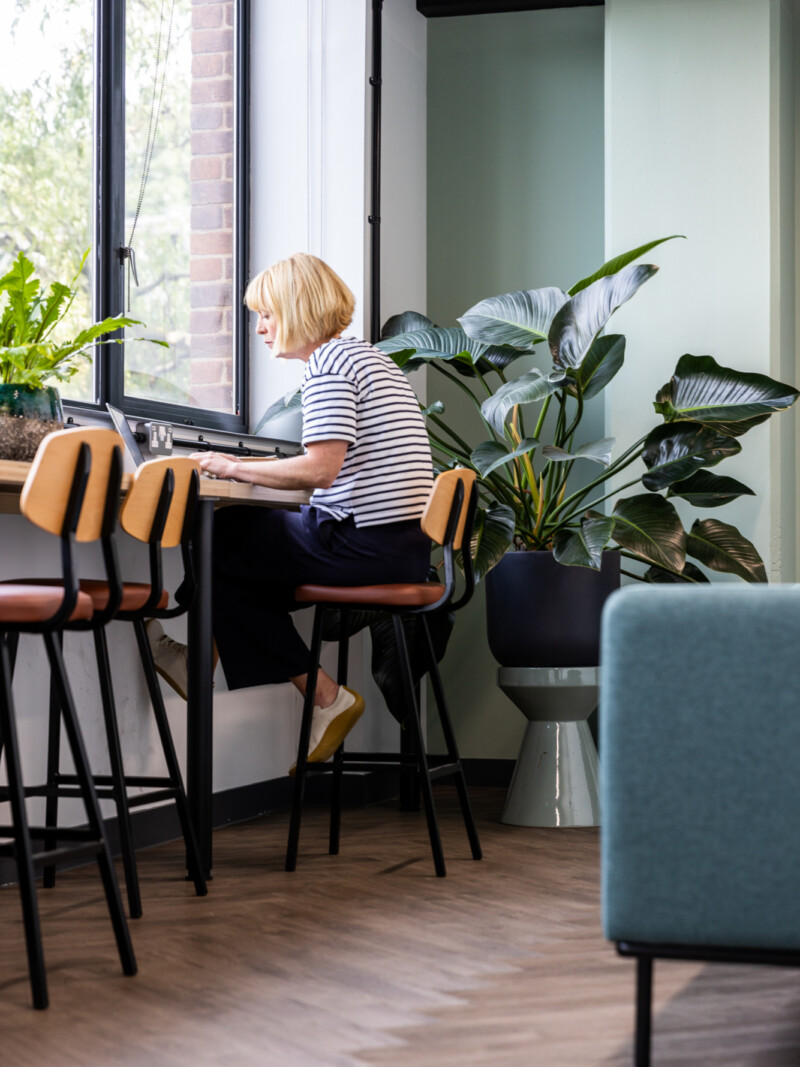 Person working at a window bench at Runway East London Bridge