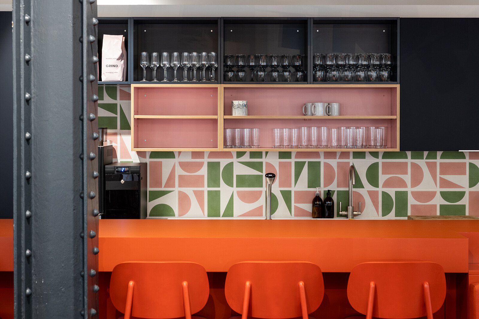 Colourful, patterned tiles on the kitchen in the breakout area of Runway East Shoreditch