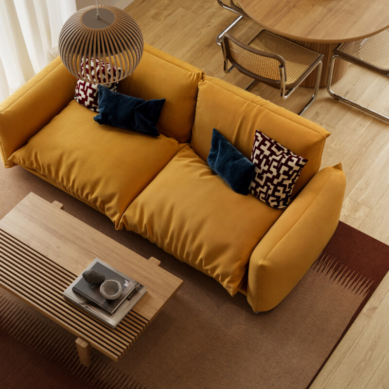 Elevated view of mustard sofa and coffee table in CGI of apartment at Stopford Park in Stockport