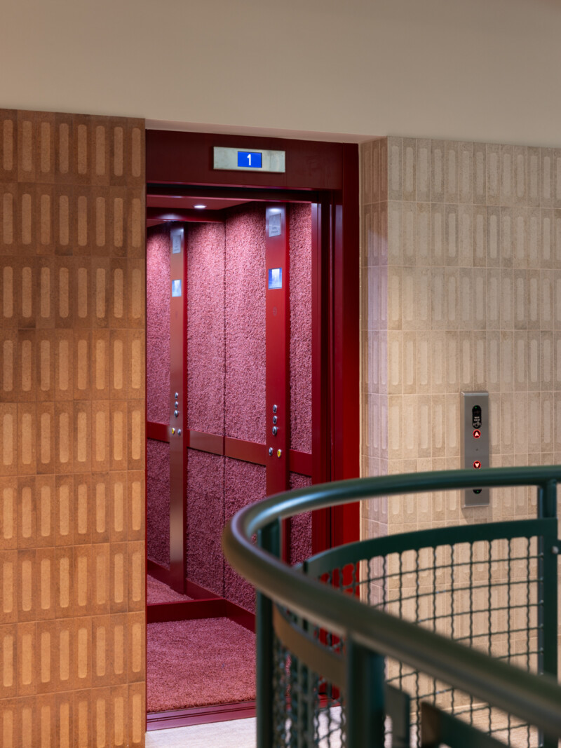 Red carpeted wall lift detail at TMT Group HQ workspace