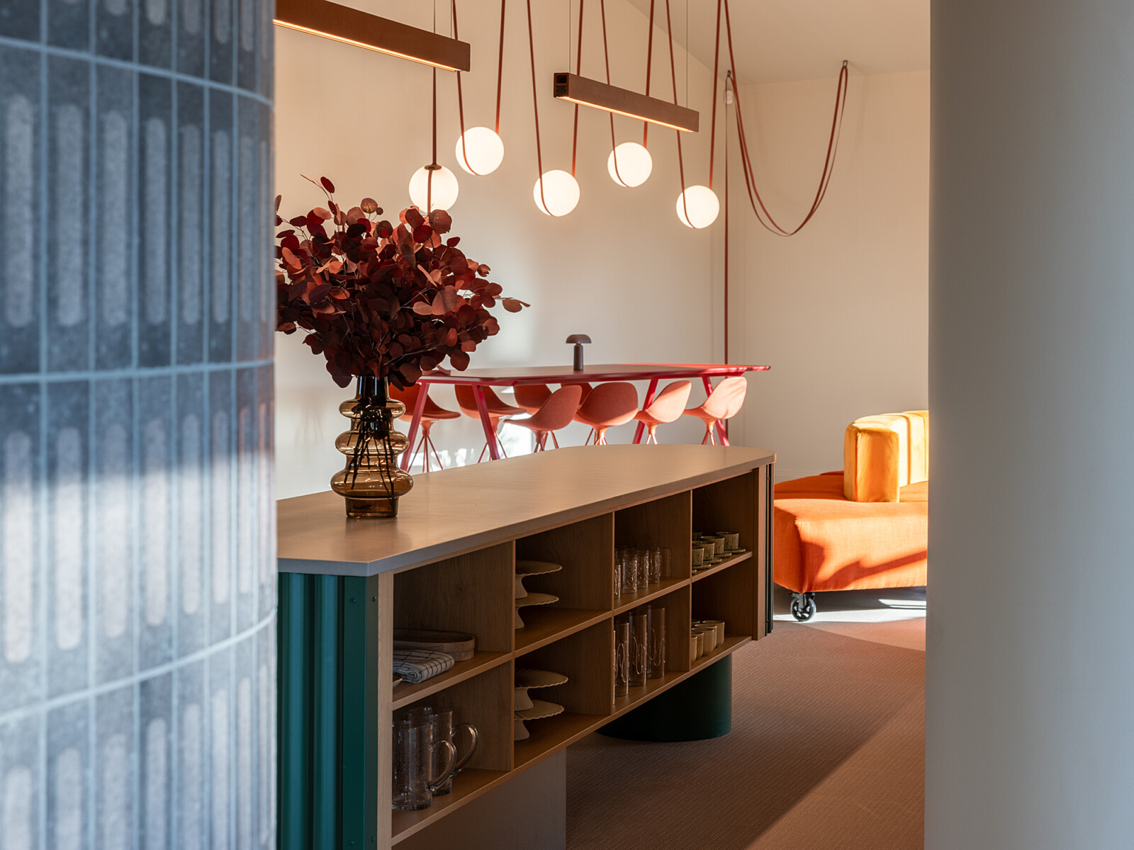 Open kitchen counter breakout meeting space and suspended pendent lights